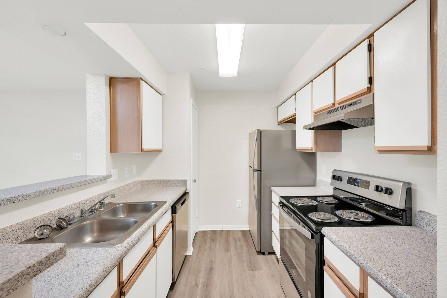 Luxury apartment kitchen with stainless steel appliances, granite countertops, and lots of storage space